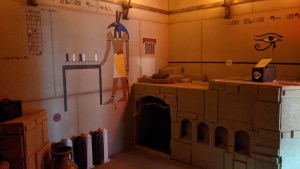 An Egyptian tomb with hieroglyphics and an assortment of obelisks.