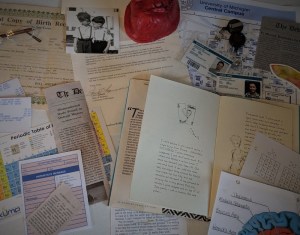A large assortment of books, letters, newspaper articles, ID badges, and other items.