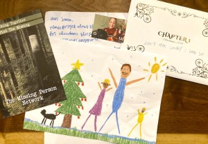 An assortment of items and letters from Dear Santa Chapter 1, including a child's drawing of his family.