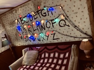 A wall with the alphabet pained on it, and a string of christmas lights over them, a la Stranger Things.