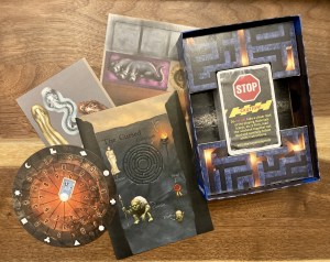 Assorted game components including a maze, a solution wheel, card deck, and instructions.