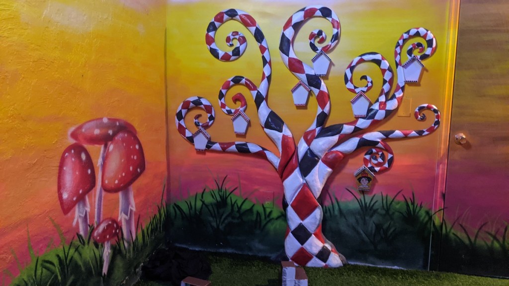 A strange red, white, and black tree in Wonderland.