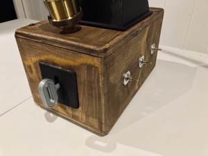 Closeup of the Tesla Box has a large 3D printed key in a keyhole.