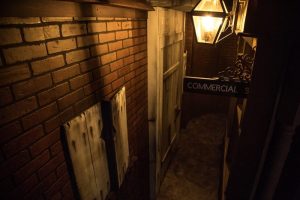 An alleyway at night in London.