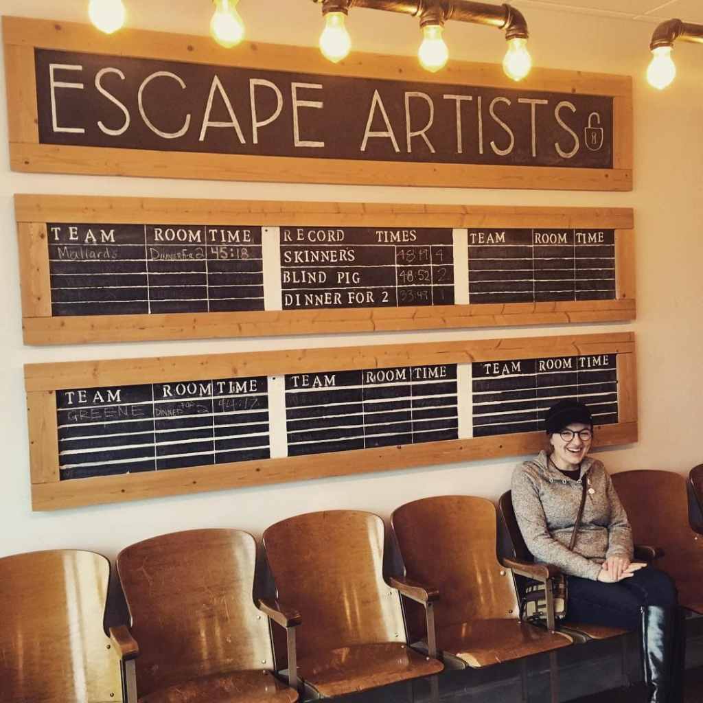 Lisa sitting in front of a leaderboard titled "Escape Artists."