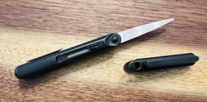 Scissor cap is removed revealing the blades.