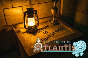 A wooden crate with a lantern and a vase on top.