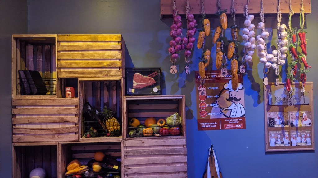 A vegetable and spice pantry made from wooden crates.