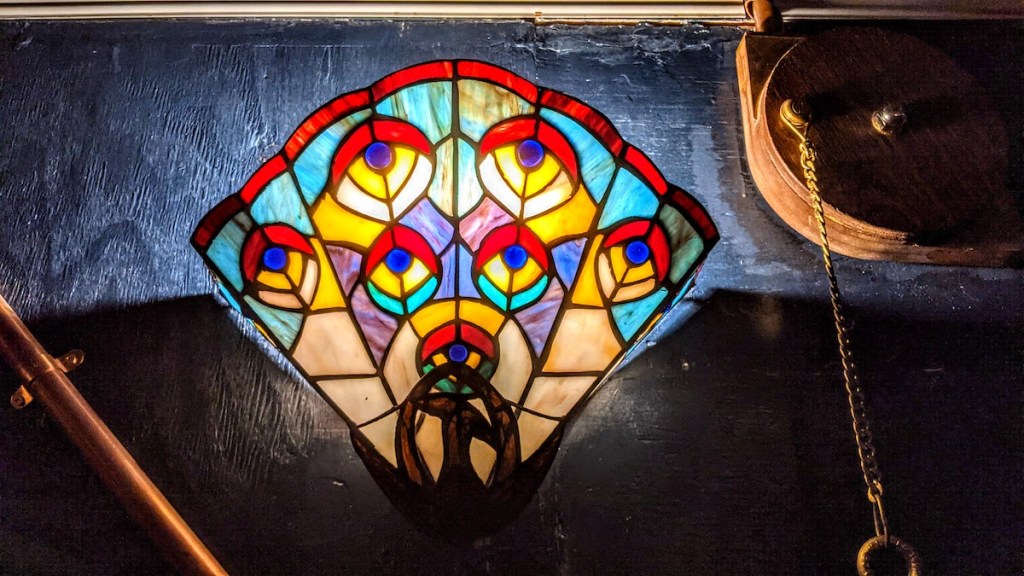 Closeup of a stained glass wall sconce.