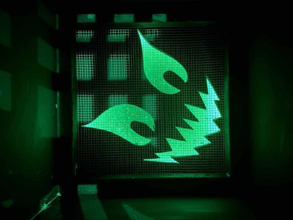 A vent grate with a spooky faec glowing through it.