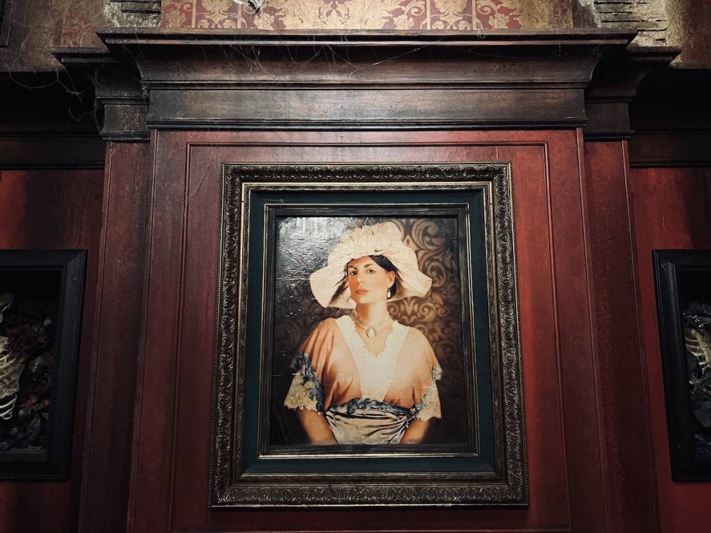 Portrait of a woman on the wall of a victorian home.