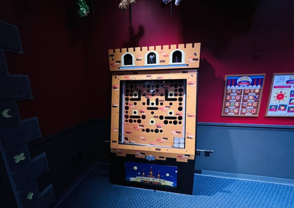 A large analog game cabinet shaped like a castle tower.
