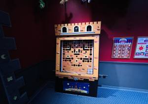 A large analog game cabinet shaped like a castle tower.
