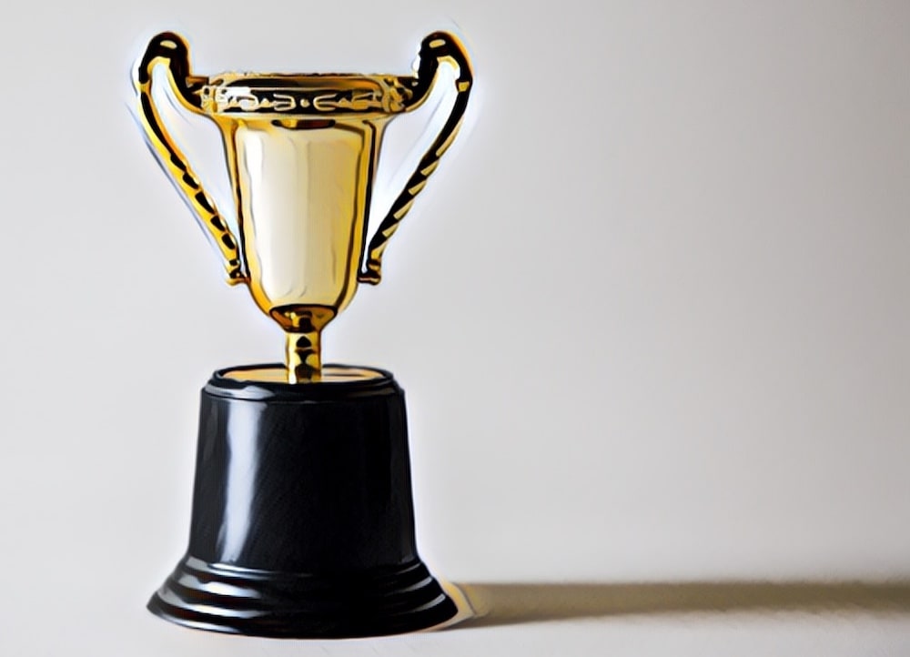 A gold trophy with a black base.