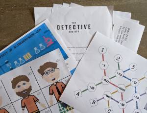 An assortment of printed paper items with colorful characters and a lab aesthetic.