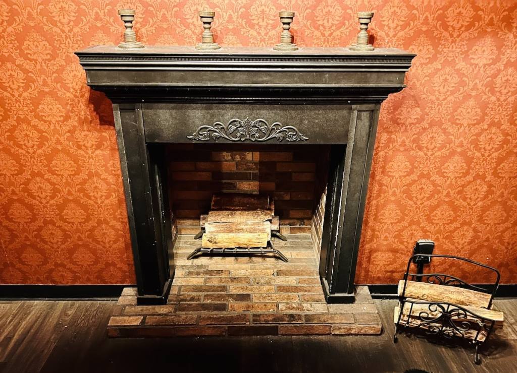 A fireplace with candlesticks.