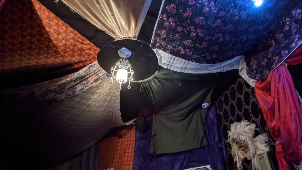 A tent ceiling made from sheets sewn toegether.