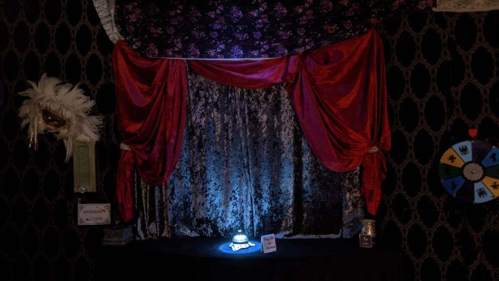 An illuminated bell in a fortune teller's parlor.
