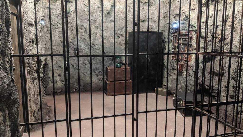 A cage set within a cave.