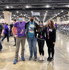 Brendan, Andrew, Theresa P, & Theresa W posing for a photo in RECON gear at PAX Unplugged 2021.