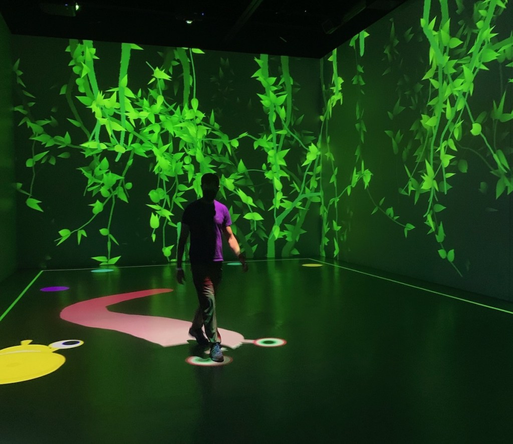 A person playing a projected version of Snake.