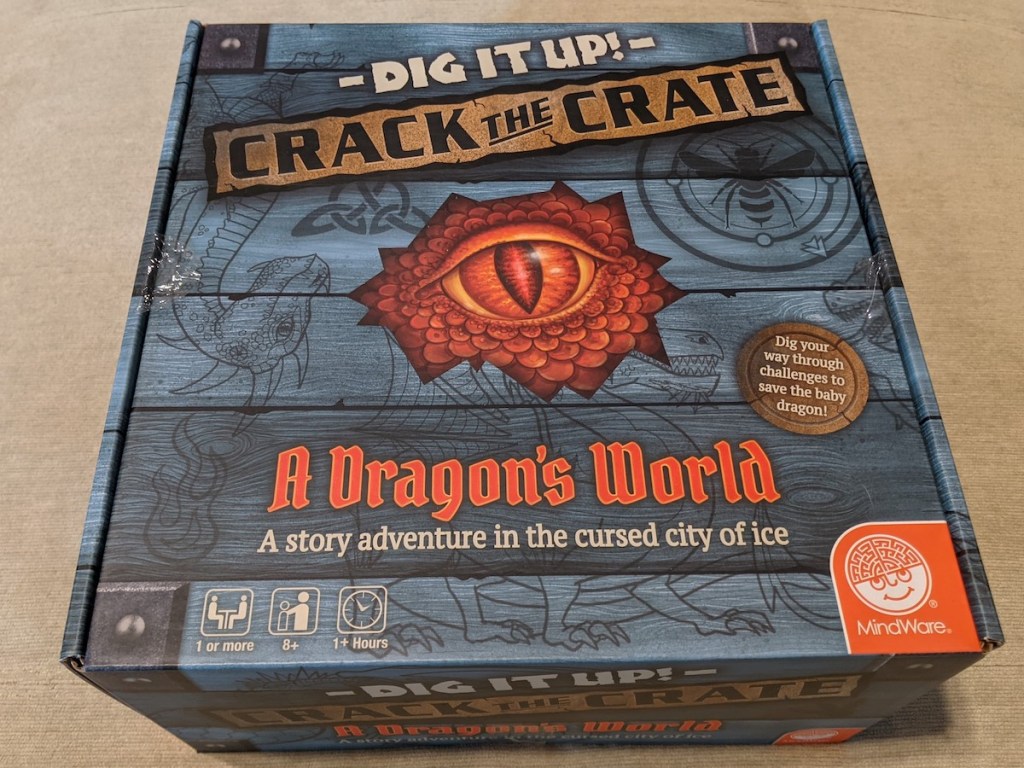 Dig It Up! Crack The Crate - a dragon's World Adventure box, looks like grey wood paneling.