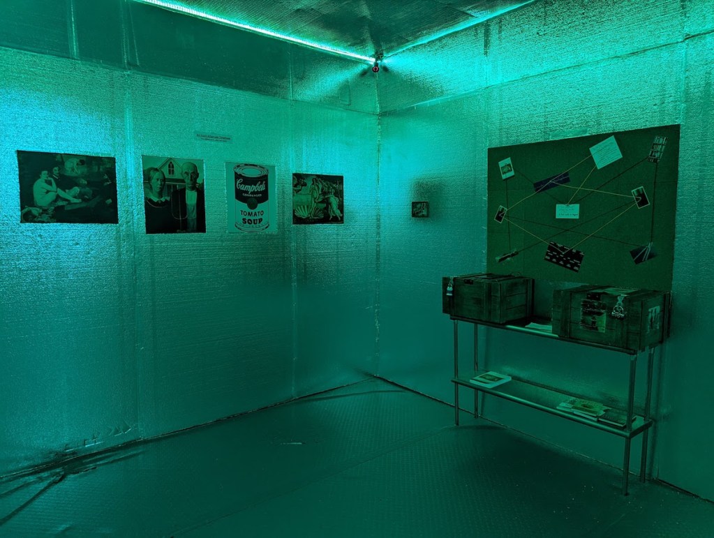A room with aluminum covered walls, kit in green. There are a few famous paintings on the walls beside a conspiracy board, and locked boxes.
