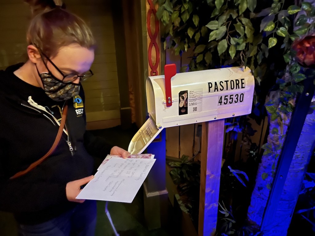 Lisa reading letters in the Pastore's mailbox.