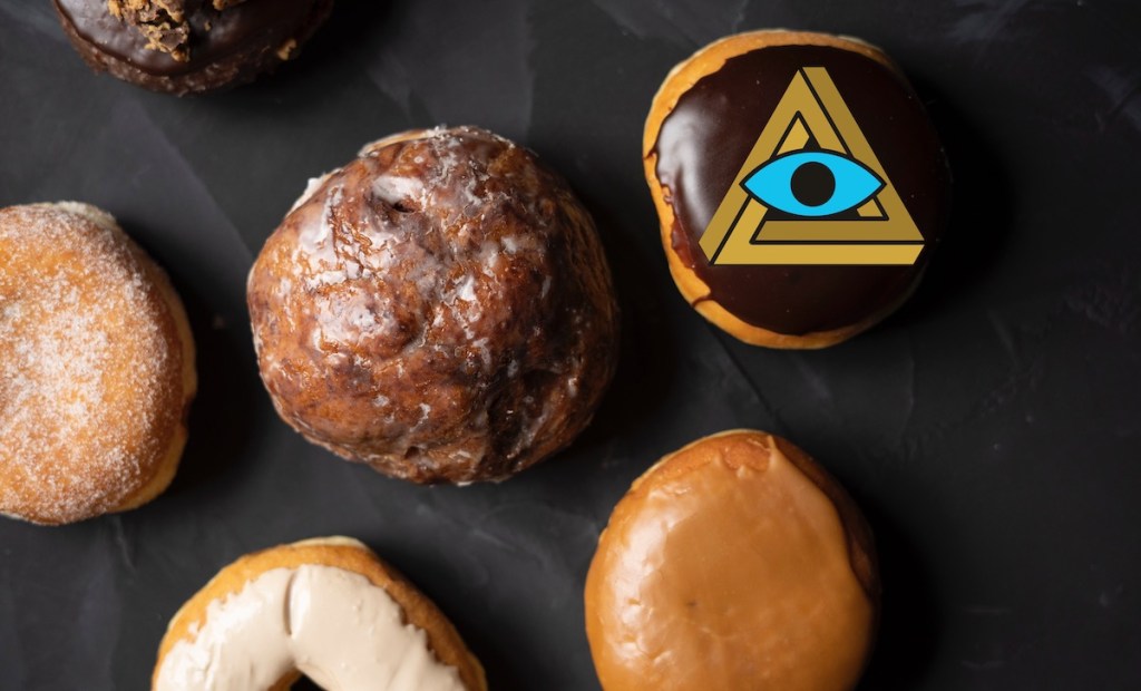 An assortment of donuts, the Boston Cream has a RECON penrose triangle logo on it.