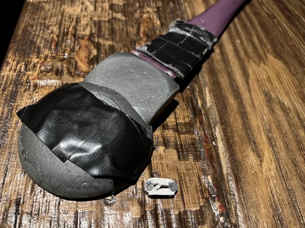 Closeup of a prop looks broken and taped together. Some of the tape looks old.