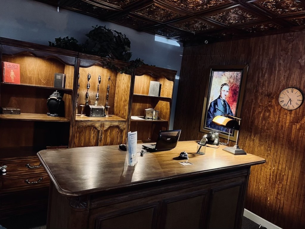 A large, wooden check-in desk in Kate's Motel lobby.