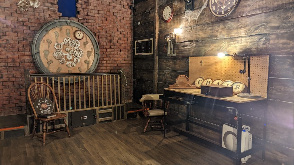 A steampunk-ish room with many clocks, gears, and a workbench.