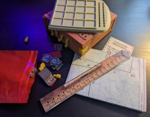 Assorted paper and plastic components. There's an interesting looking box with 4 switches on it.