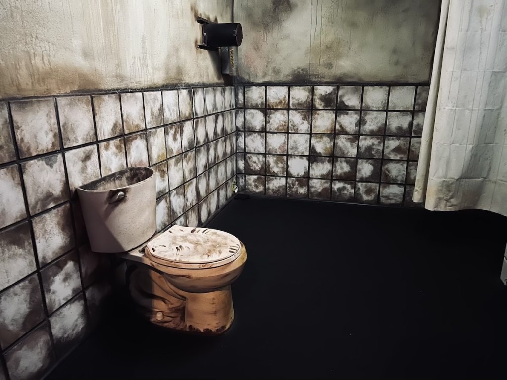 SAW-like escape room with dingy tiles and a toilet.