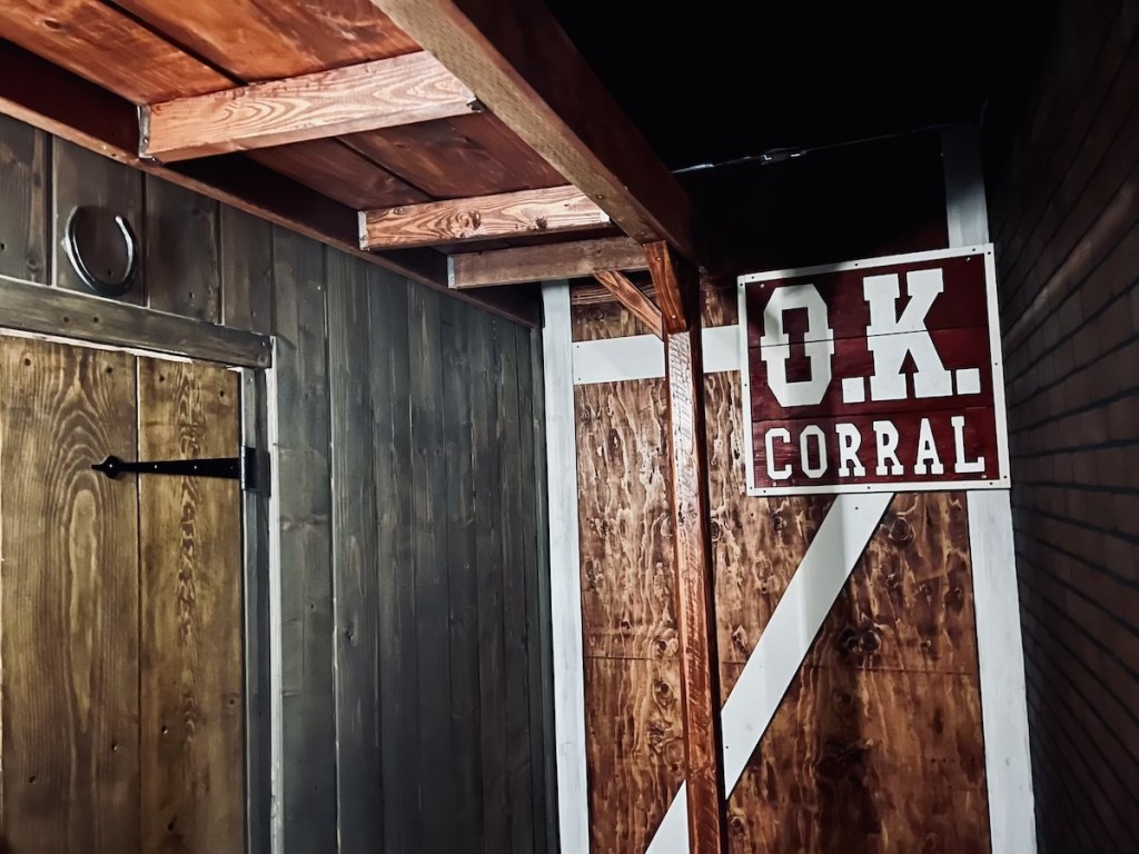 OK Corral sign hung from a barn.