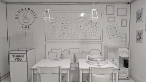A cafe where literally everything is painted black & white. The wall reads, "Black & White Cafe."