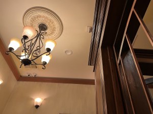 Upward view of a bank with an elaborate light fixture.
