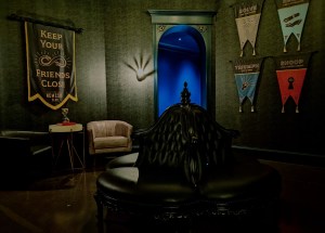 Nemesis Club lounge has a 1920's villainous vibe with banners representing different virtues.