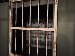View of a the sign for Alcatraz viewed through rusting bars.