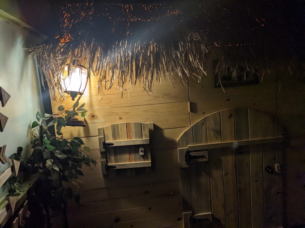 A wooden wall with a few small compartment doors.