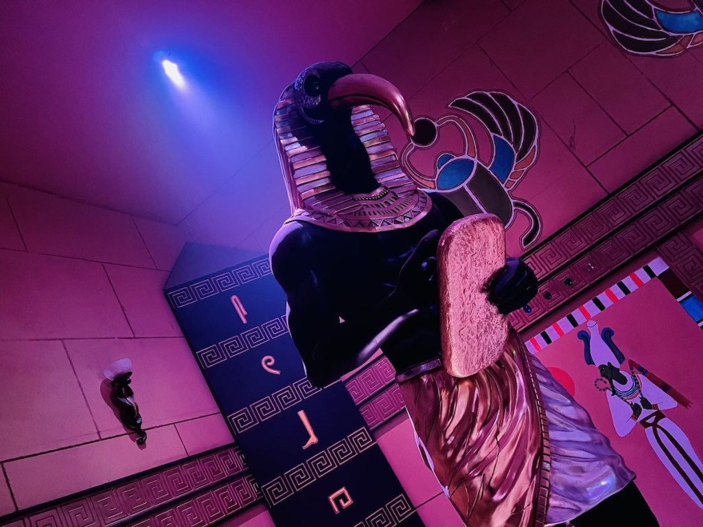 Imposing statue of Thoth in an Egyptian tomb.