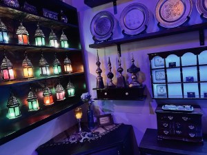 A shop filled with middle eastern lanterns and plates.