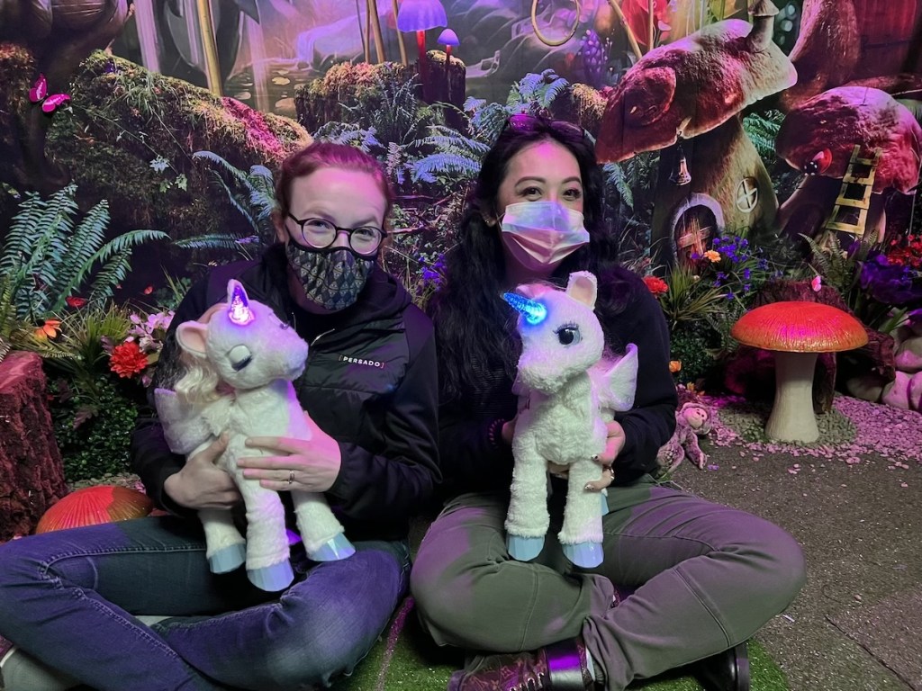 Lisa and Peih-Gee sitting together cuddling baby unicorns.