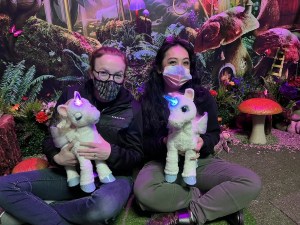 Lisa and Peih-Gee sitting together cuddling baby unicorns.