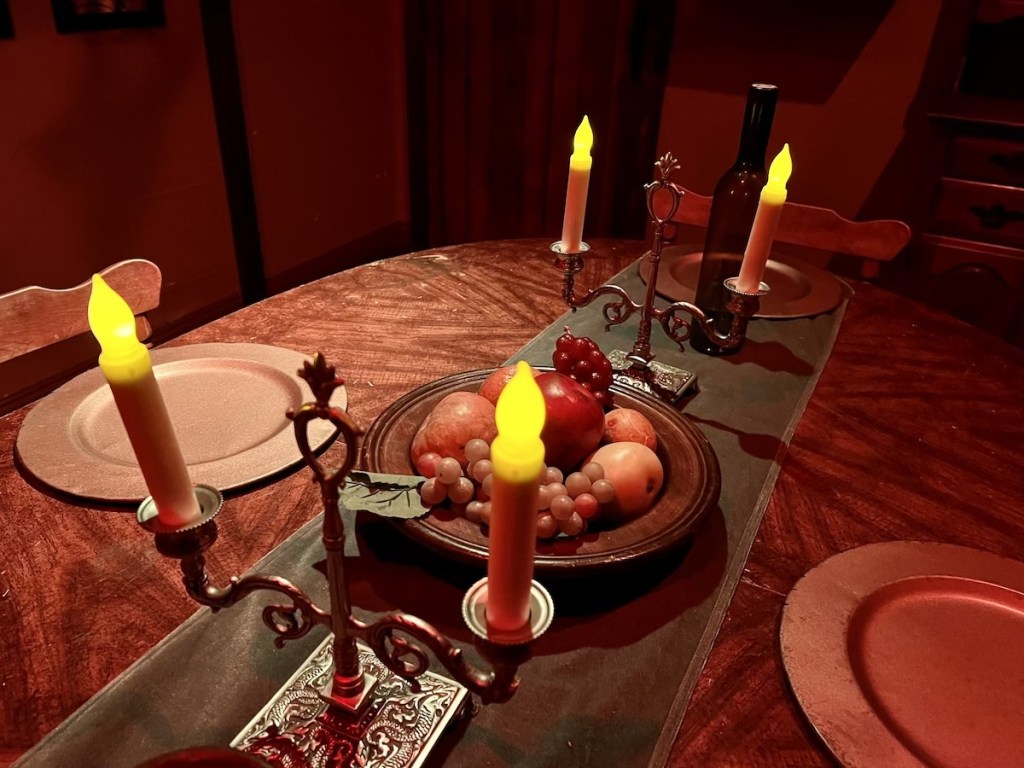 Closeup of the dinner table with a bowl of fruit in the center.