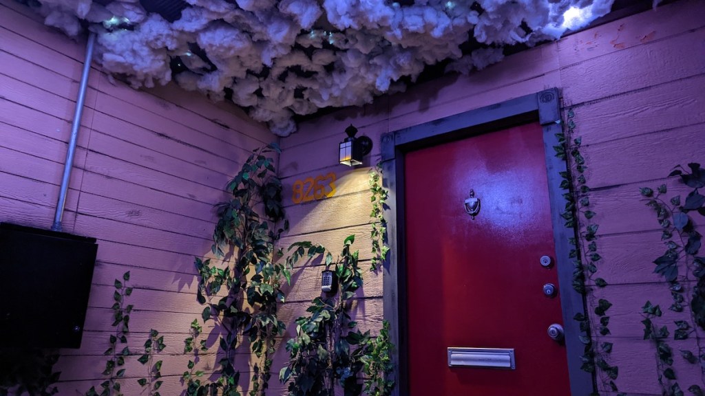 The front door to a house, above it are storm clouds.