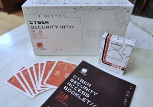 Cyber Security Kit box, a deck of cards, and a booklet.
