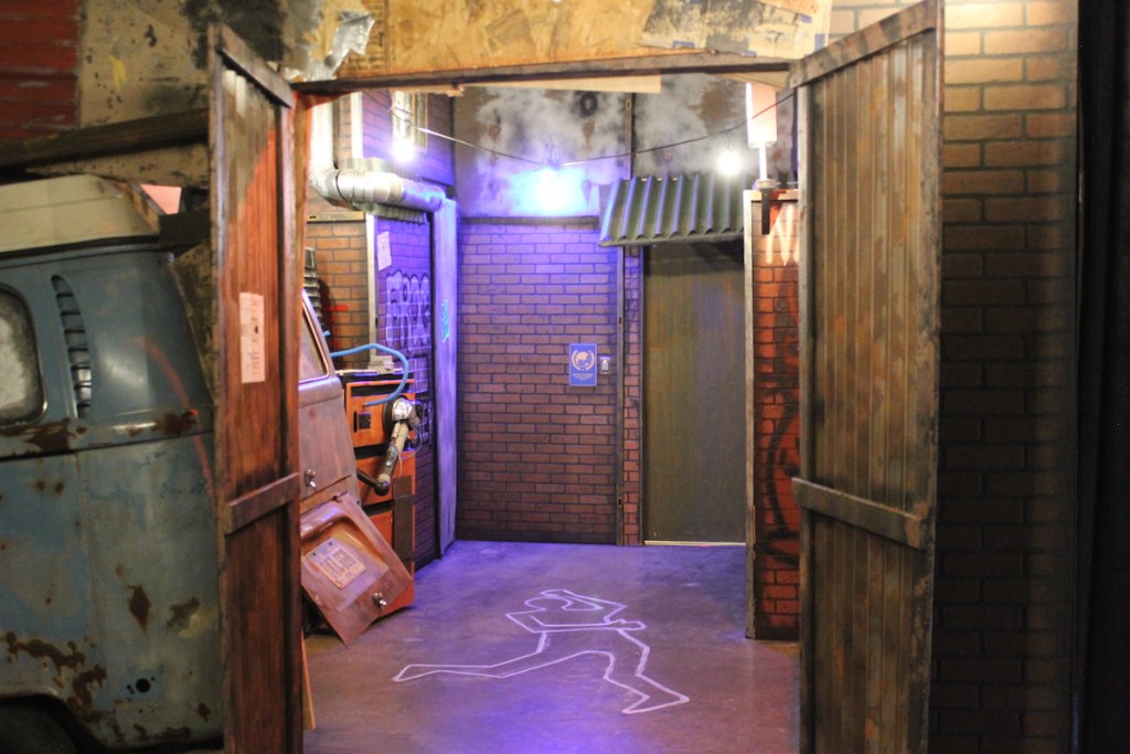 Chalk outline of a body in an alleyway.