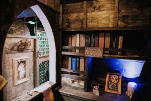 A wizard's study with books and trinkets.