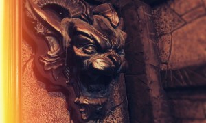 Closeup of a sculpture of the head of an unusual beast.